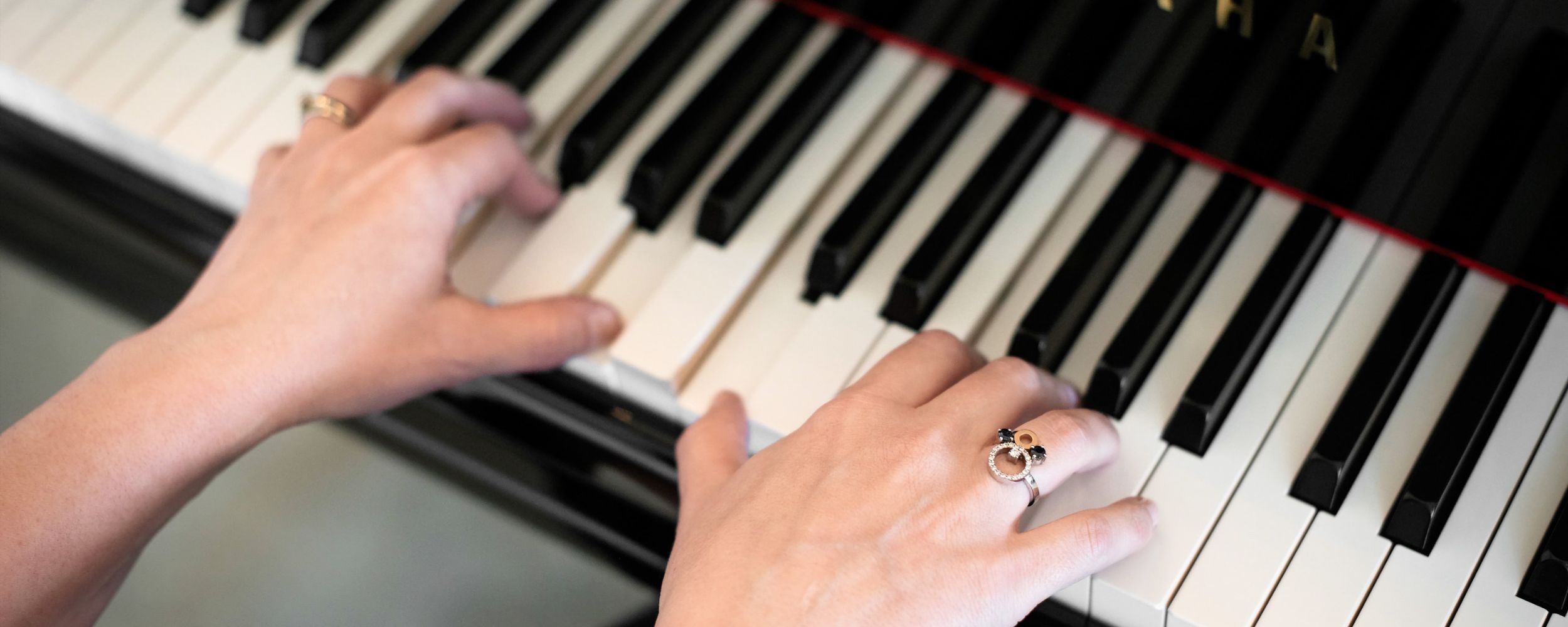 Pianist Kimberley Dunn performing on a Yamaha grand piano, providing elegant live music for a funeral service.