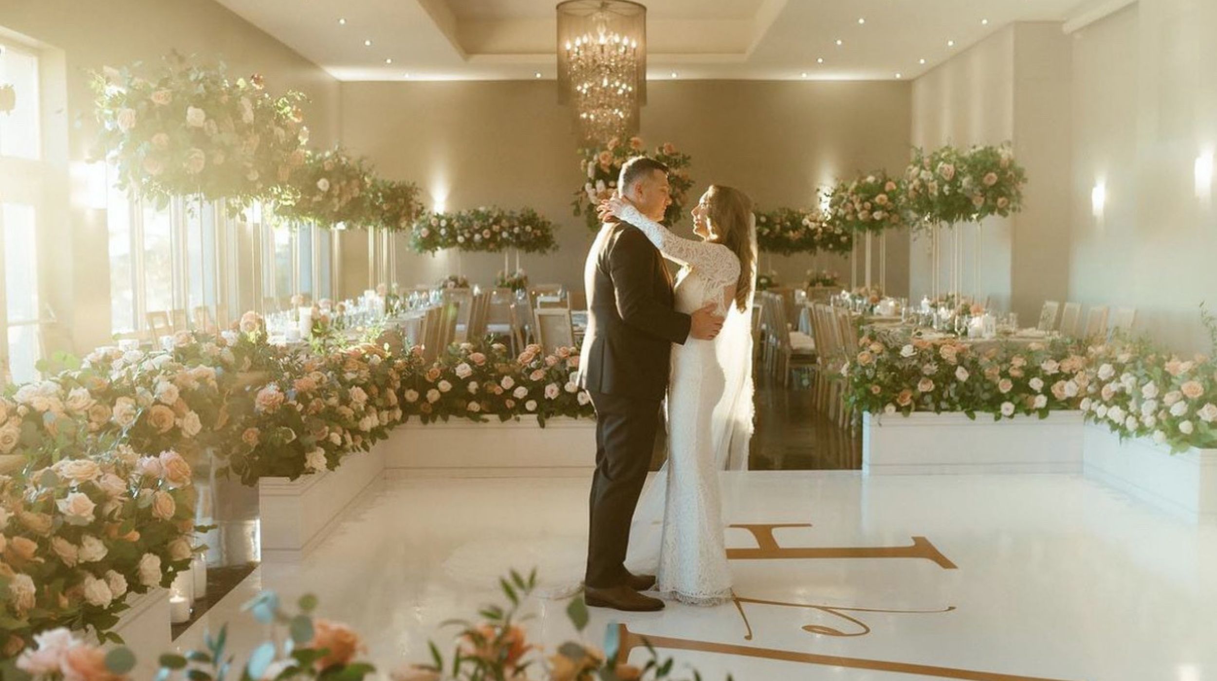 A wedding couple sharing a dance at Le Belvedere during a reception.