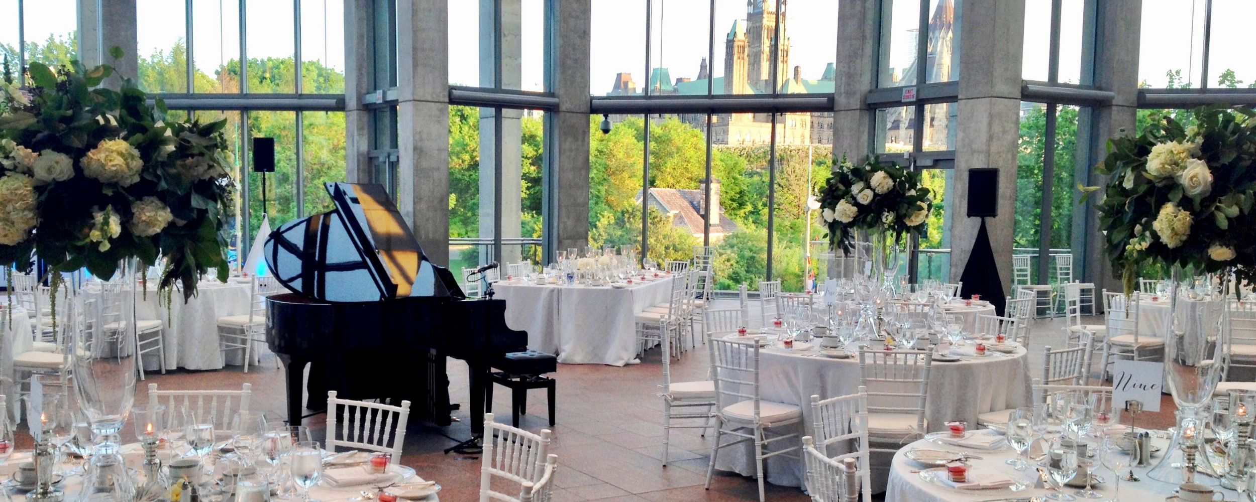 A rental grand piano positioned for a wedding ceremony in the Great Hall at the National Gallery of Canada.